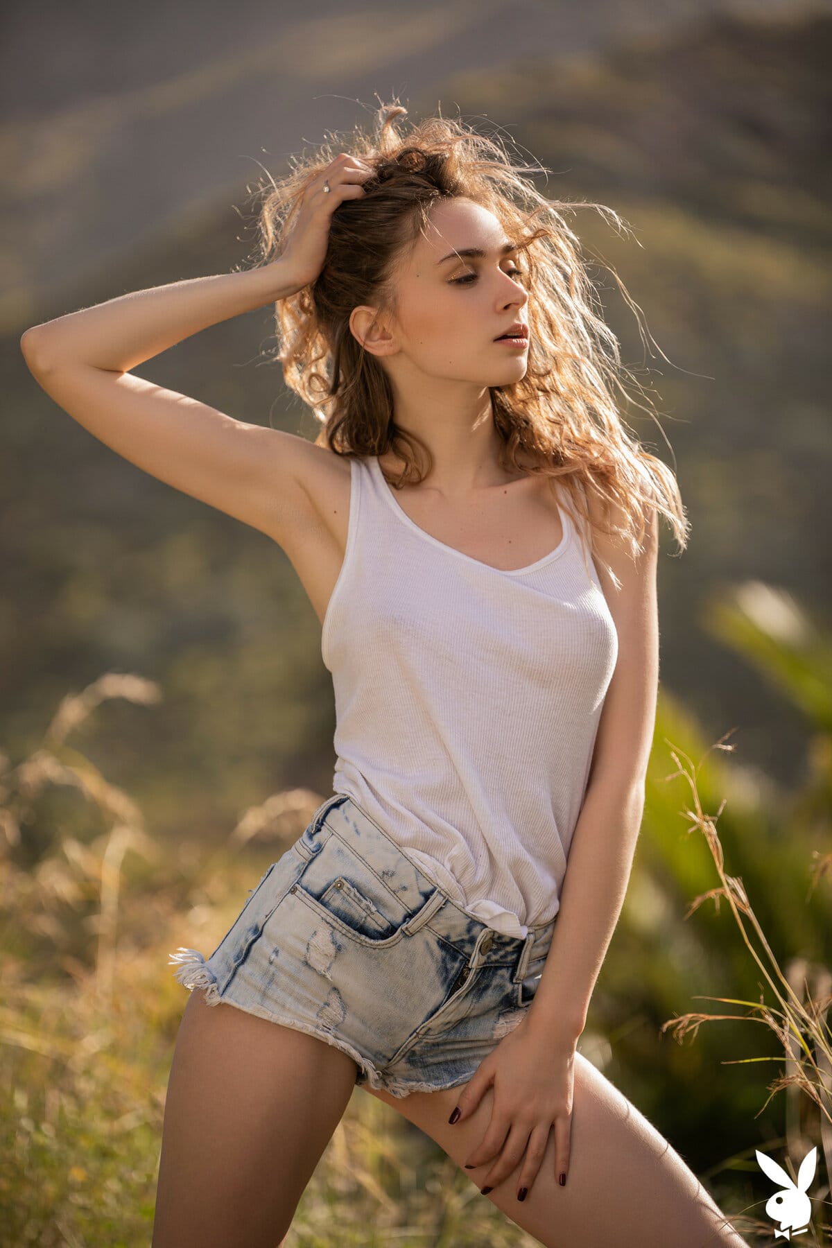 Yana West undresses, exhibiting her petite figure around the mountains