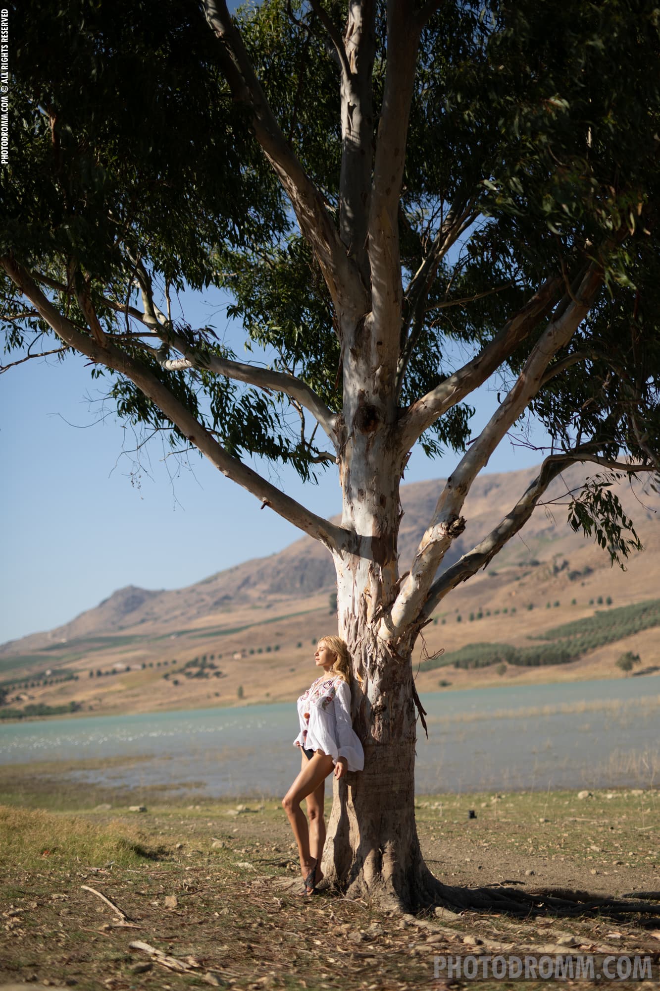 Darya enjoying the sunshine nude by a tree