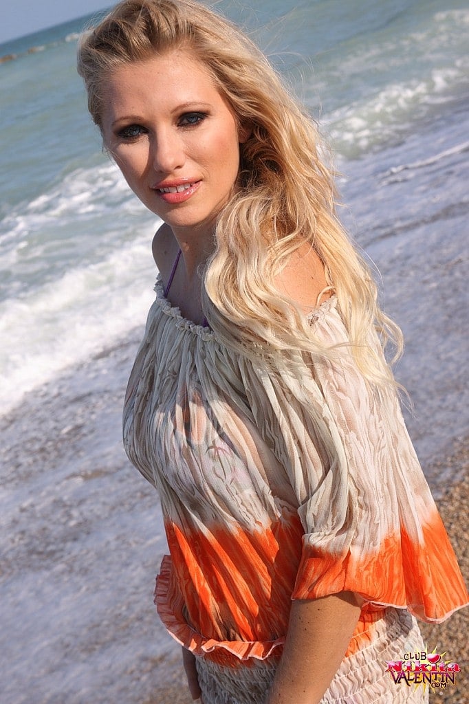Nikita at the beach strips out of her bikini